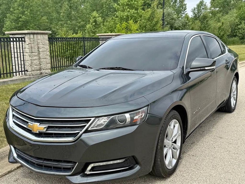 Dark gray Chevrolet sedan parked on the road.