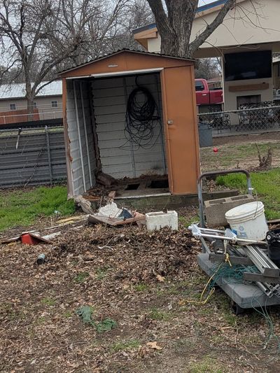 Shed in the backyard of a home in Benbrook Texas that was removed by Herrera Hauling junk removal 