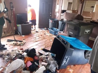 House cleanout in Fort Worth with junk removal trailer loading furniture, trash, and household items