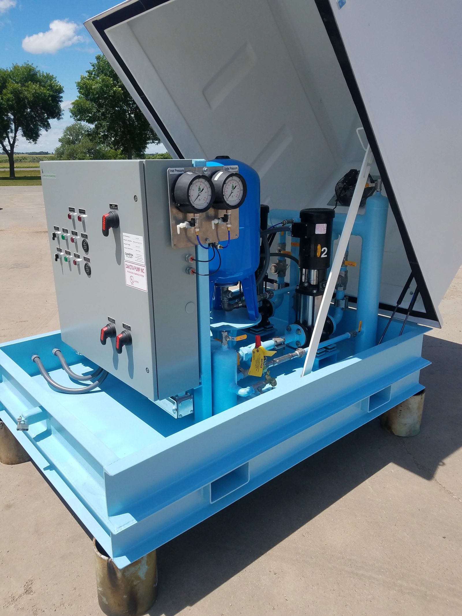 Above grade water booster with cover open