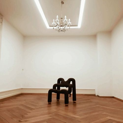 Stack of books next to pencils in a holder and a camera.