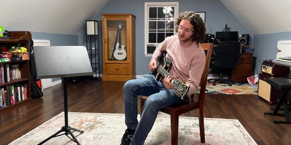 Man playing guitar in a cozy room.