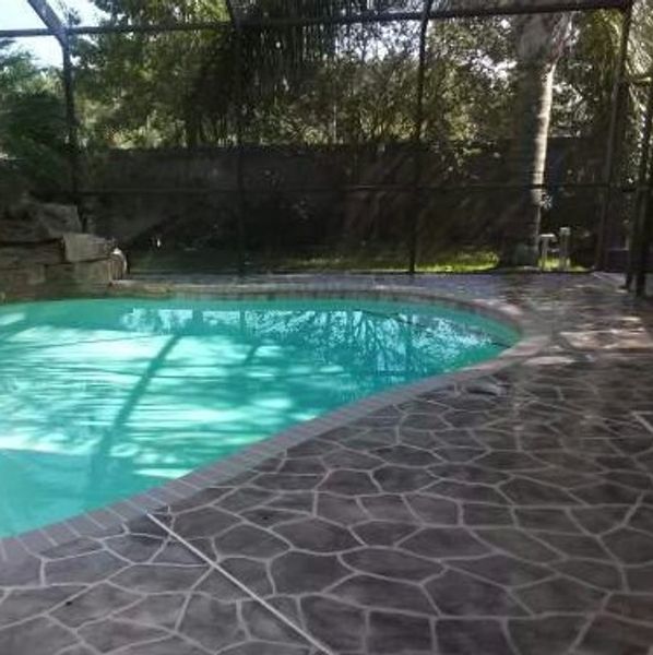 A swimming pool deck with a stencil design