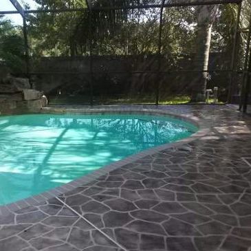 Swimming pool deck with a stencil design.