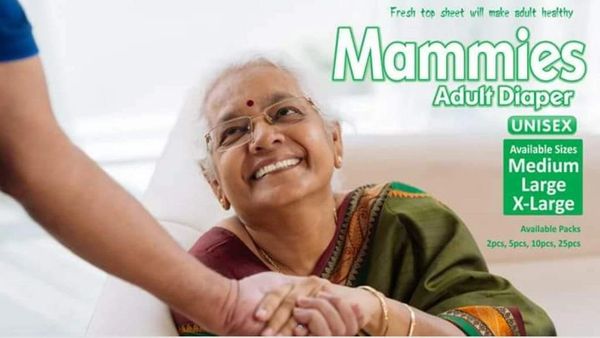 Smiling elderly woman with adult diaper advertisement, holding hands with a caregiver.