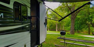 relaxing view of an RV, the meadow and the river