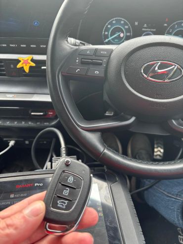 Car key fob held inside a Hyundai vehicle.