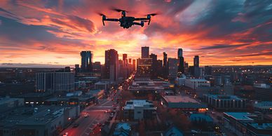 a drone approaches a city skyline with a red setting sun in the background 