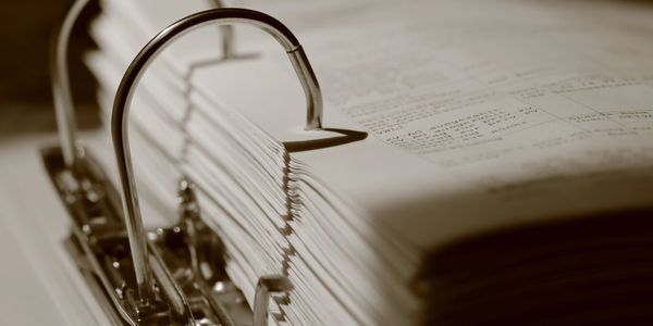 Close-up of a stack of documents in a binder.