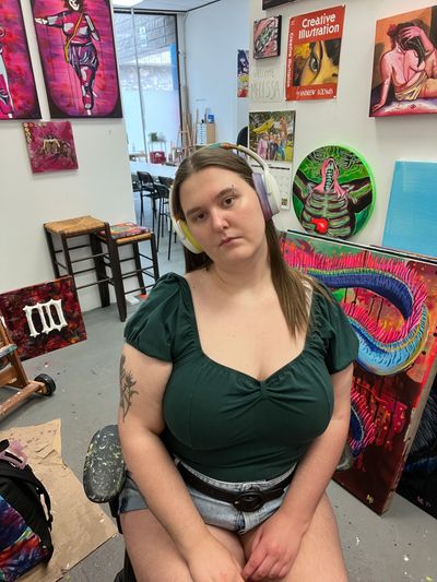 Young woman with headphones in an art studio.