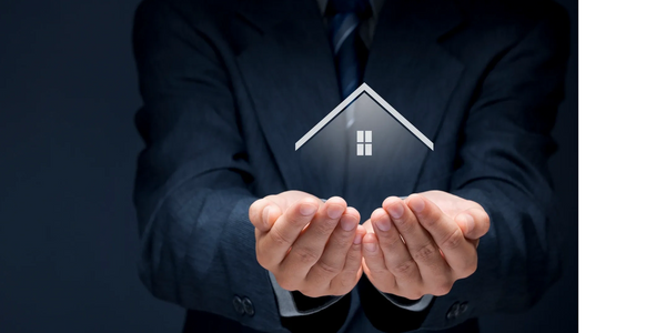 Person holding a tiny home in outstretched hands