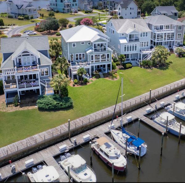 Waterfront homes near a marina with boats docked.