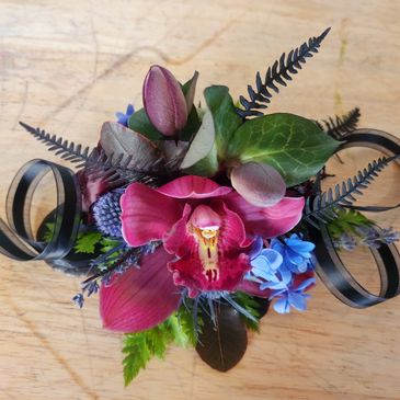 Fuchsia cymbidium corsage with hellebores and thistle accents. 