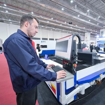 Man operates industrial laser cutter