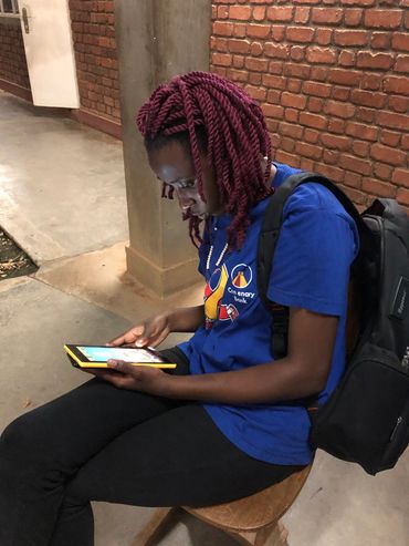 Teenage girl looking at a Tablet in her hands.