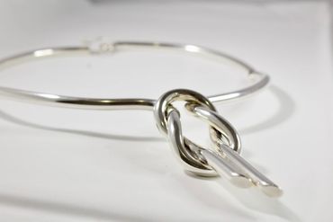Silver bracelet with knot design.