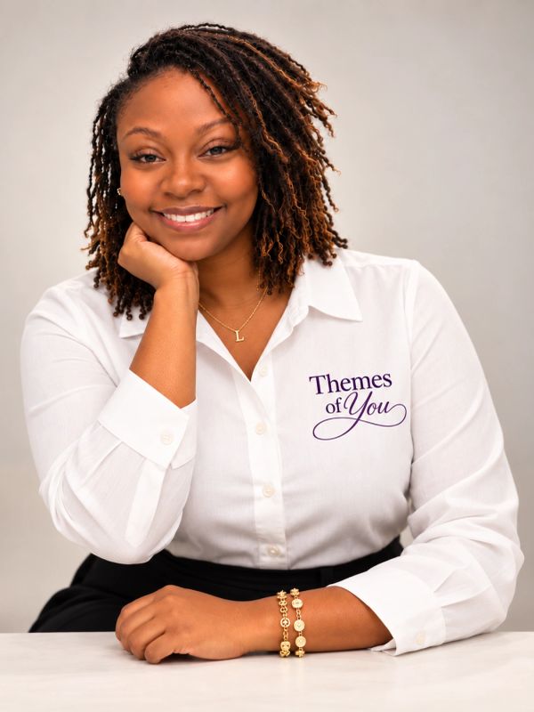 Smiling woman in a white shirt with 'Themes of You' logo.