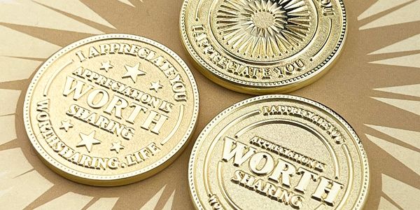 Three gold appreciation coins with star patterns.