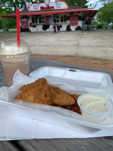 Alt="Chicken fingers, ranch dressing, and a MooSa's soft-serve custard shake"