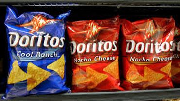 Alt="Doritos cool ranch and nacho cheese bags on a shelf a MooSa's"