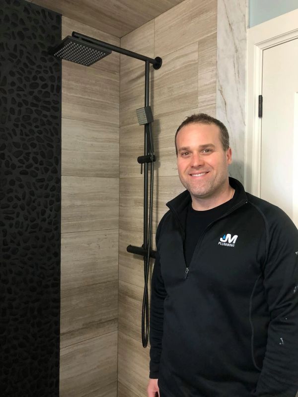 Man smiling in a modern shower area.