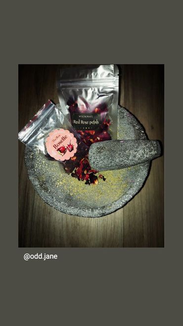 Red rose petals and Roselle buds crushed in a molcajete to bring passion and love