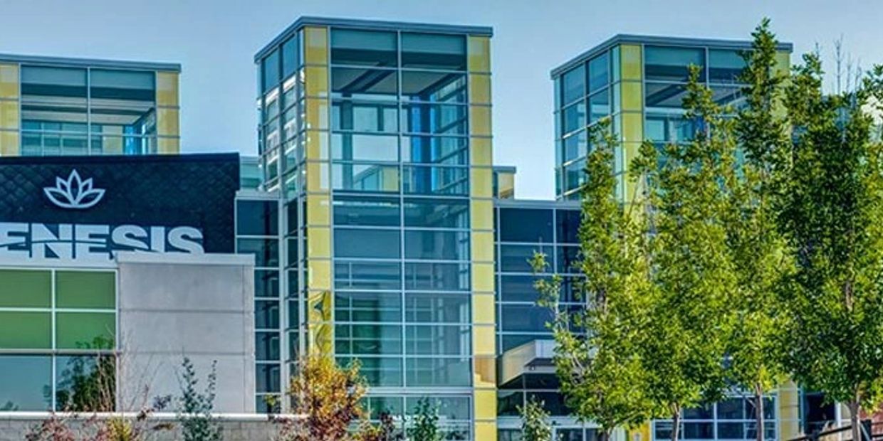 Modern building with glass facades and yellow accents.