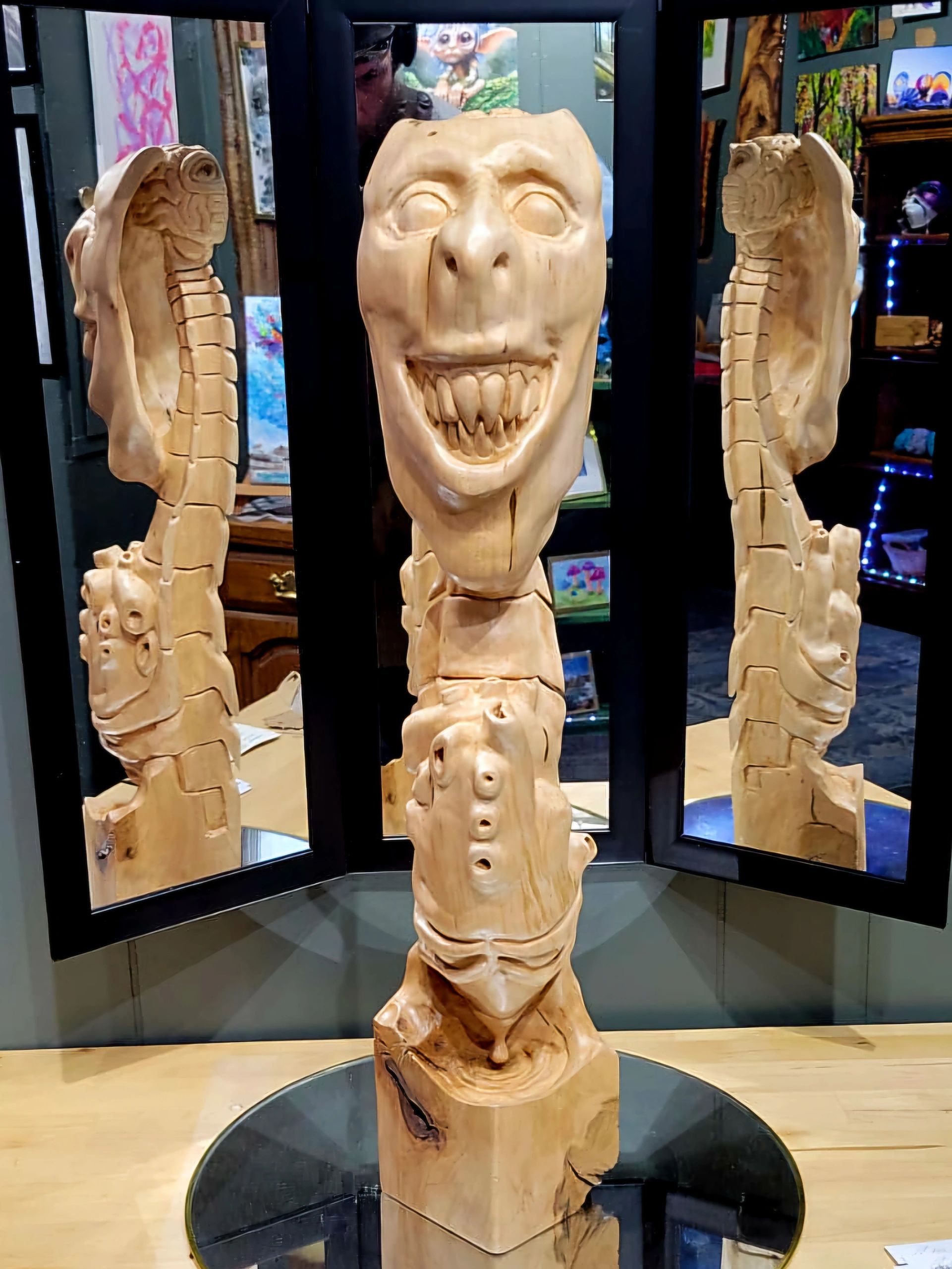 sculpture by artist Chad Rev Art depicts a creepy face, toothy smile, heart, spine and brain