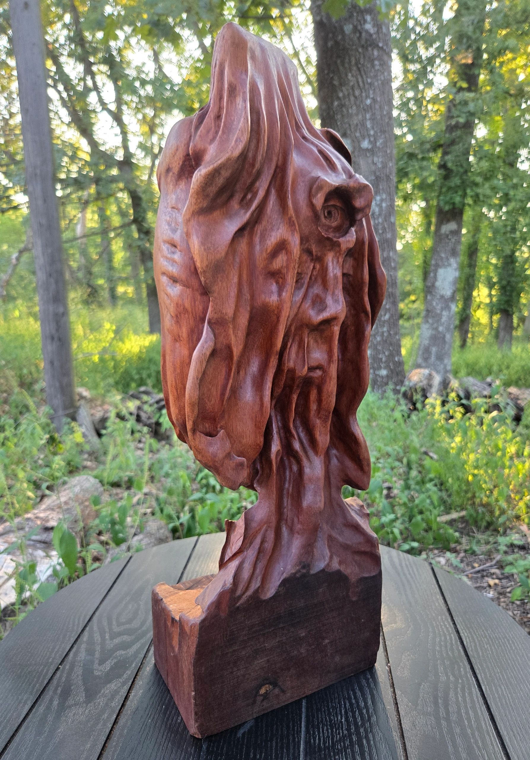 A womans veiled faced carved from Brazilian Mahogany by Chad Rev 