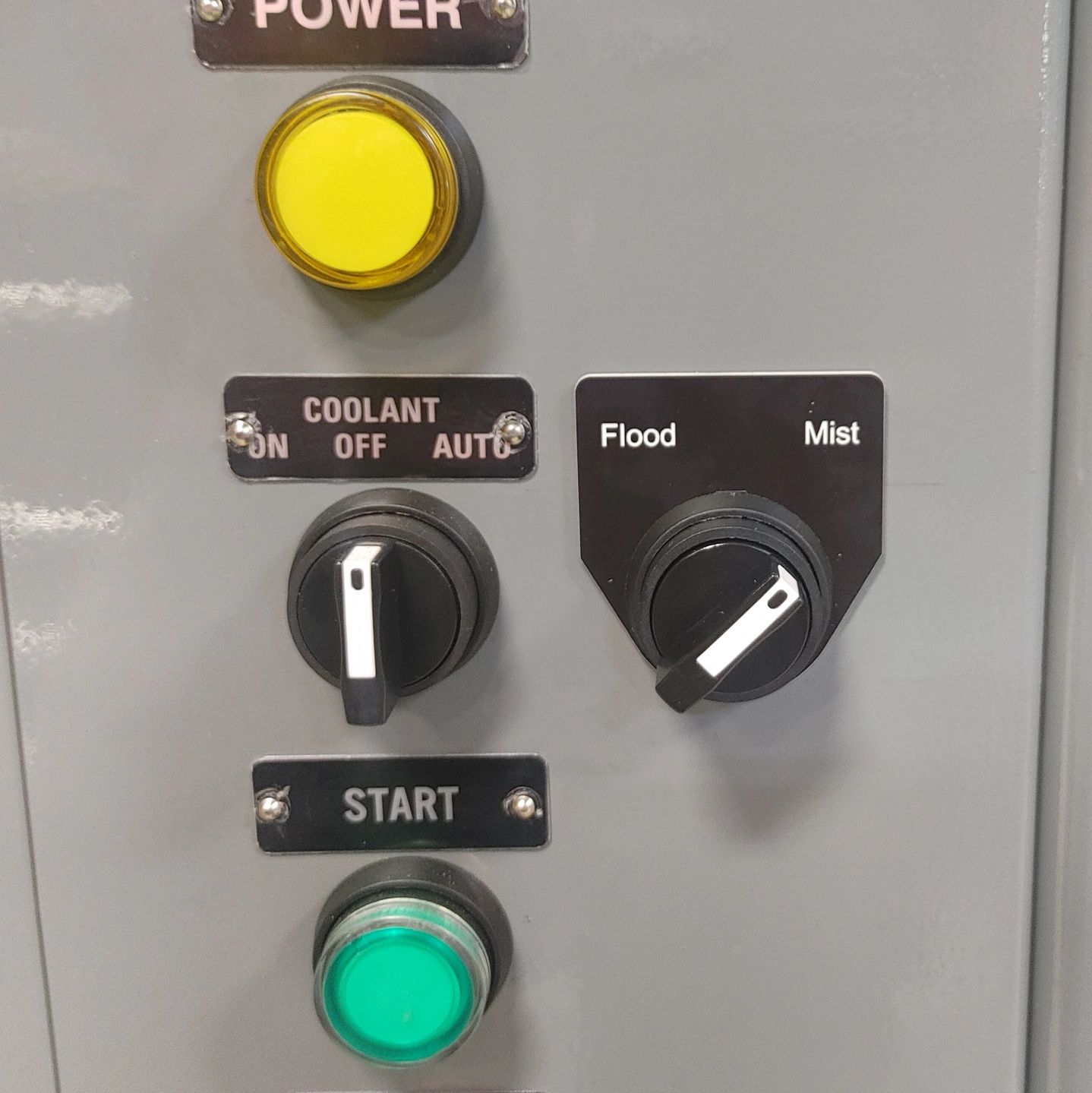 Control panel with switches and buttons for power, coolant, and flood/mist settings.