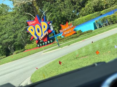 Colorful Disney Pop Century Resort entrance sign with bright decorations.