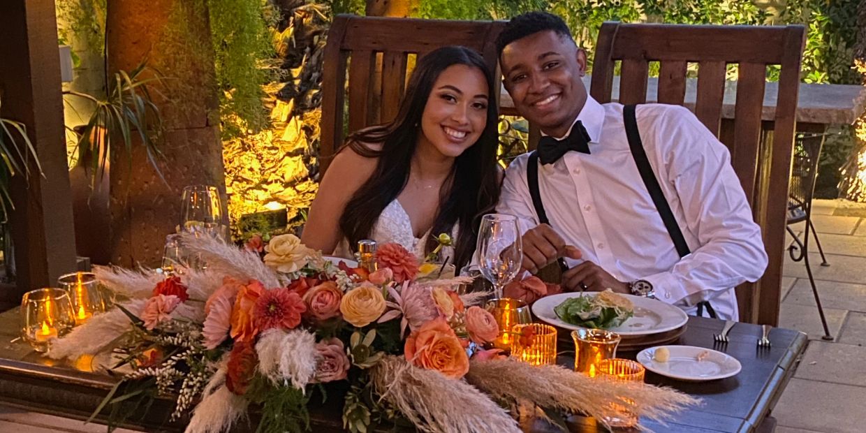 Ethnic couple bride and groom at wedding reception table.