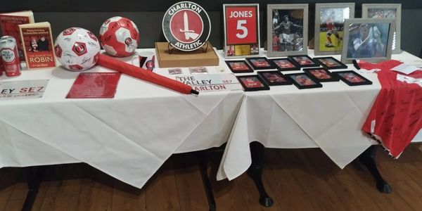 Memorabilia display featuring Charlton Athletic items and framed photos.