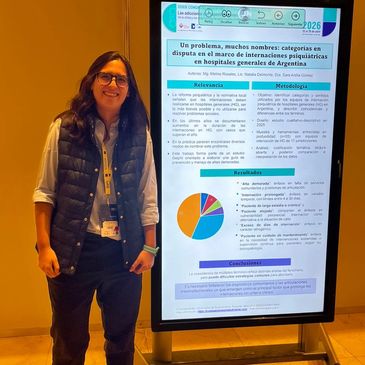 Woman standing next to a scientific poster presentation with charts and text.