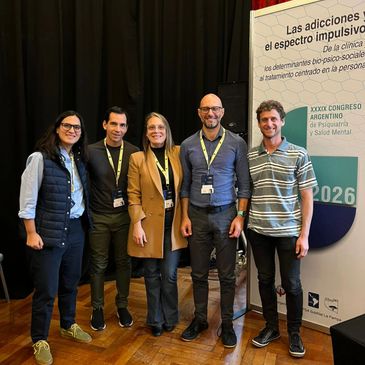 Five people posing at a mental health conference in Argentina.