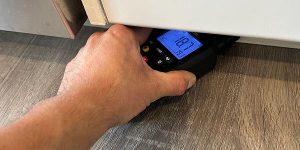 Animikii Restorations - Moisture check with an MR77 Moisture Meter