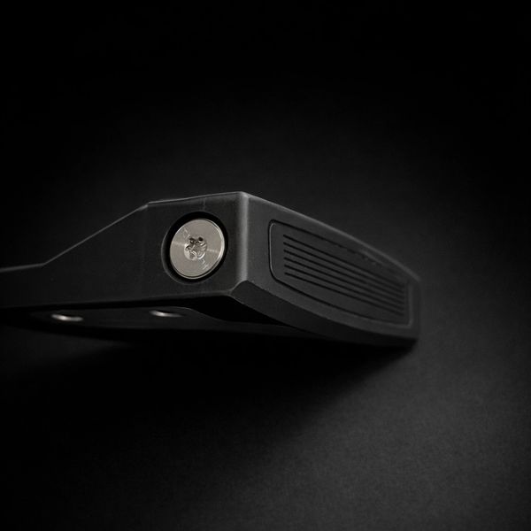 Close-up of a black lock on a dark background.