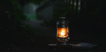 A lantern glowing in the dark.