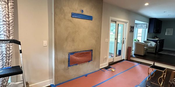 Living room with fireplace under renovation.