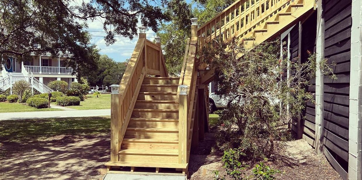 Newly built wooden stairs attached to a building outdoors.