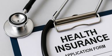 A stethoscope resting on a health insurance application form.
