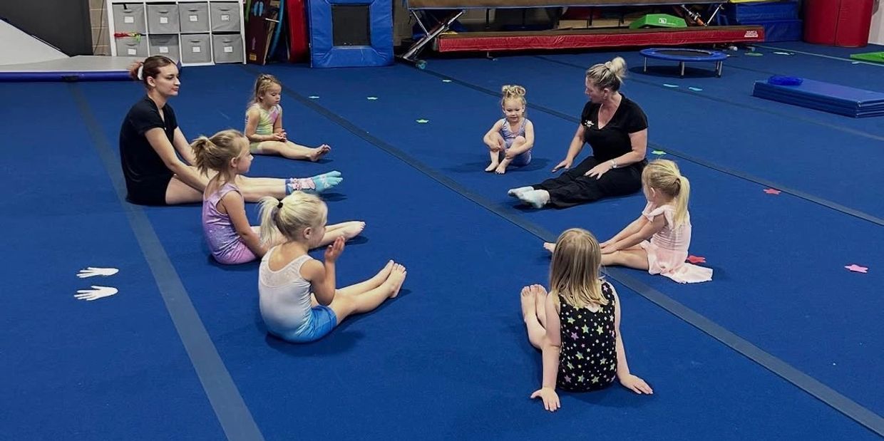 Group of Preschoolers and Coaches Stretching