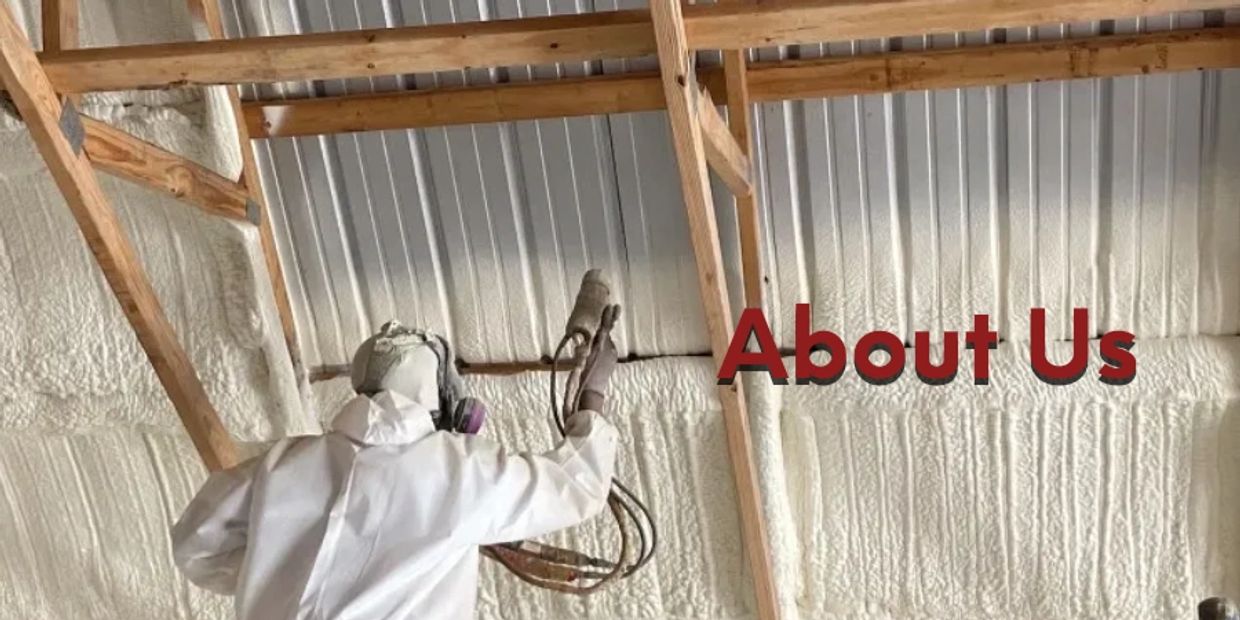 Man spraying foam on a steel building.