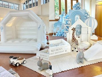White bouncy Castle, soft play, cars, hoppers, & safari balloon decor at children's party in Ewell