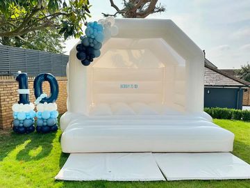 White Bouncy Castle with custom writing, balloon garland & number stack for kids birthday event