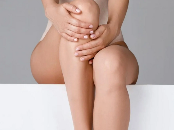 a person holding knee with both hands 