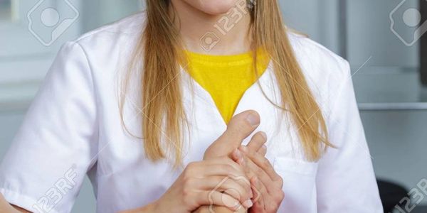 Medical professional holding a patient's hand for comfort and support.