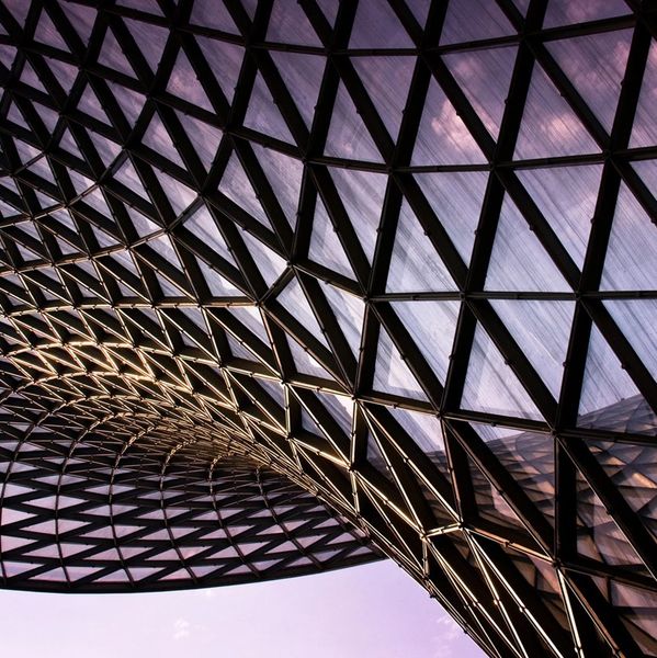 Intricate modern architectural glass roof with geometric patterns.