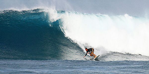 Gene Gore, owner of South Padre Surf Company surfing at Sunset Beach Hawaii