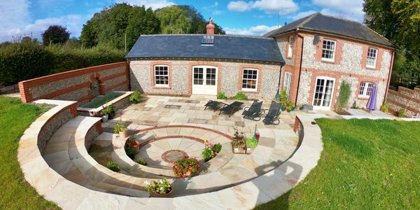 Beautiful backyard with a sunken circular garden and patio.